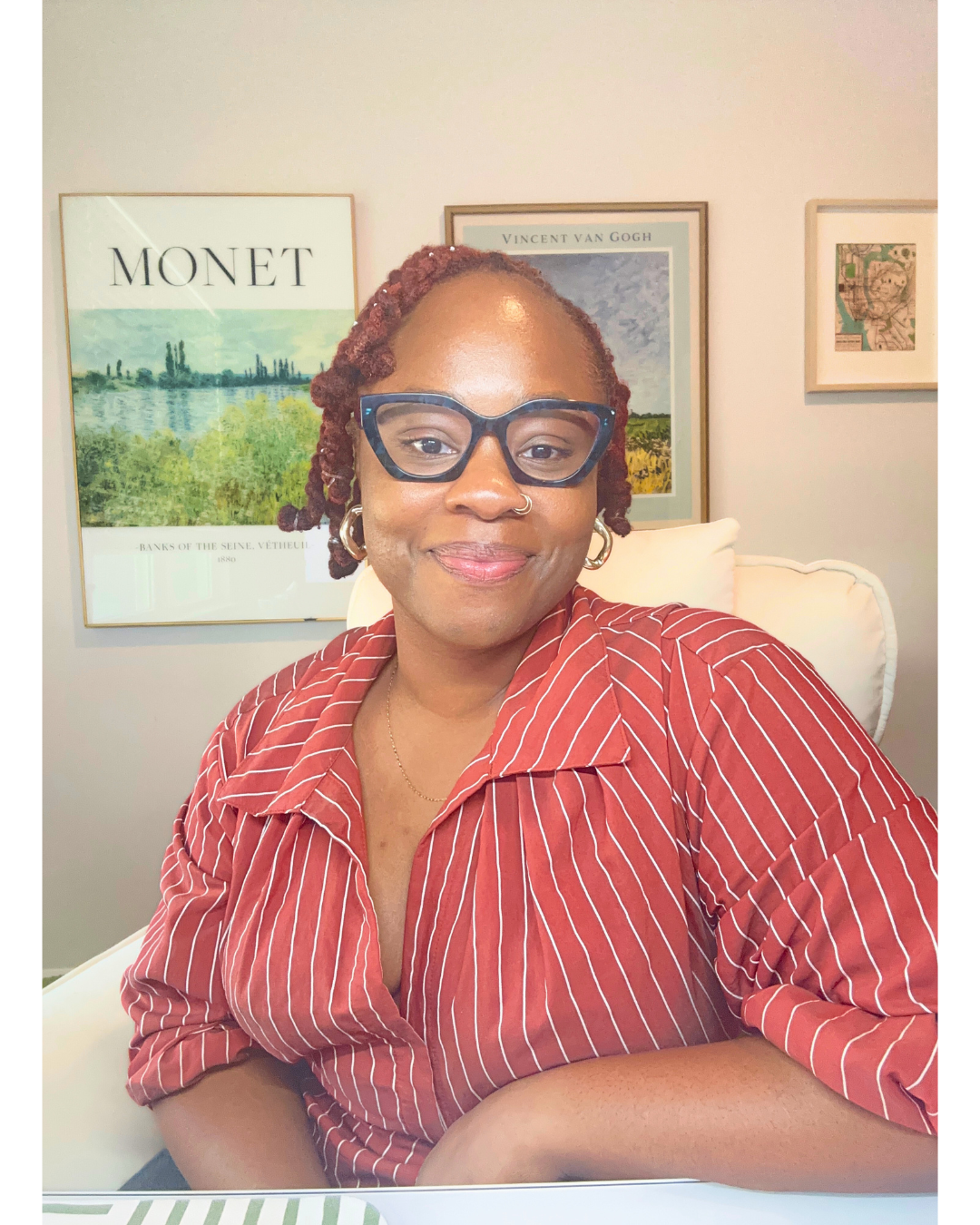 Bintu Tiamiyu seated, wearing a red striped shirt